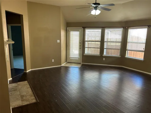 a view of room with window and wooden floor