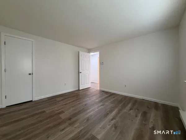 a view of an empty room and wooden floor