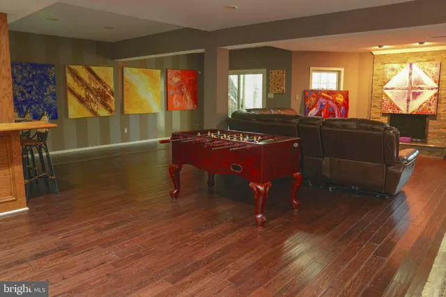 a living room with furniture window and wooden floor
