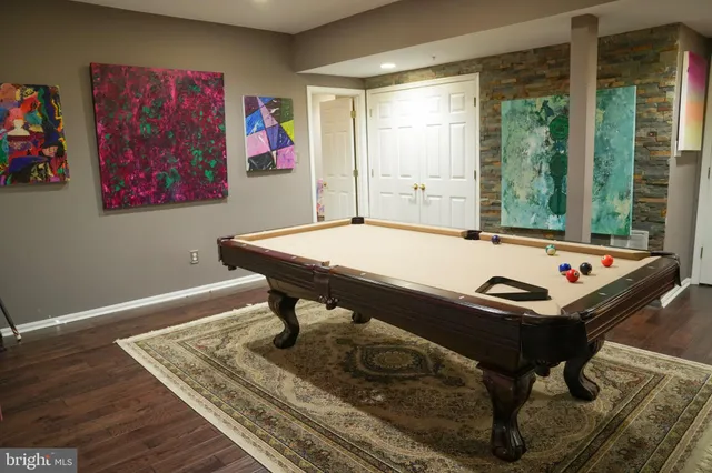 a room with furniture pool table and windows