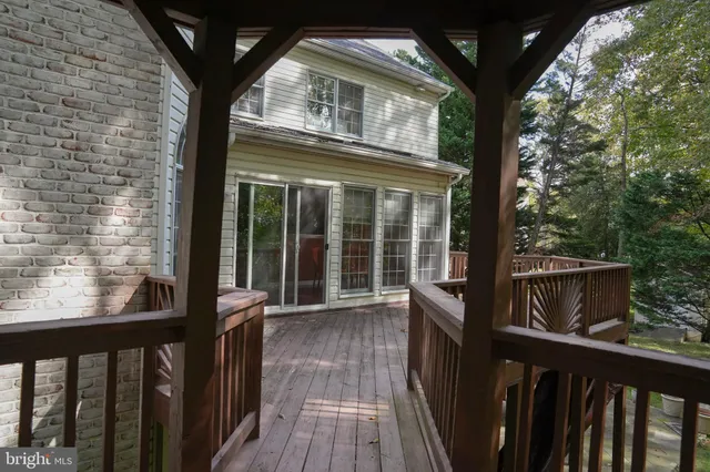 a view of a balcony with wooden floor and fence