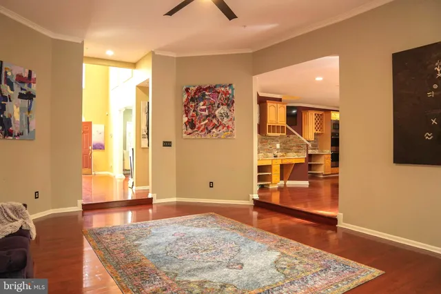 a view of a livingroom with wooden floor and a rug