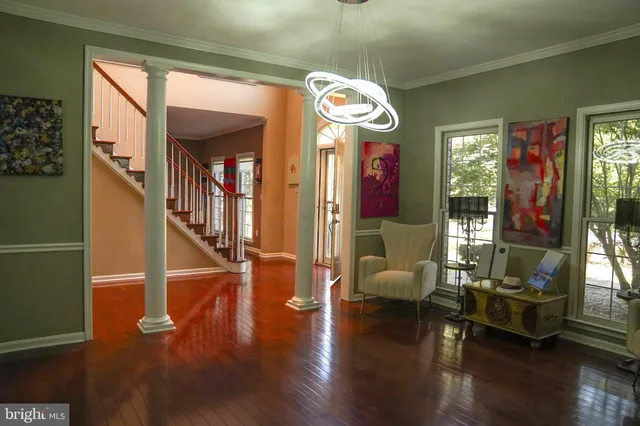 a hallway with furniture and wooden floor