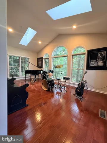 a living room with furniture fireplace and a large window