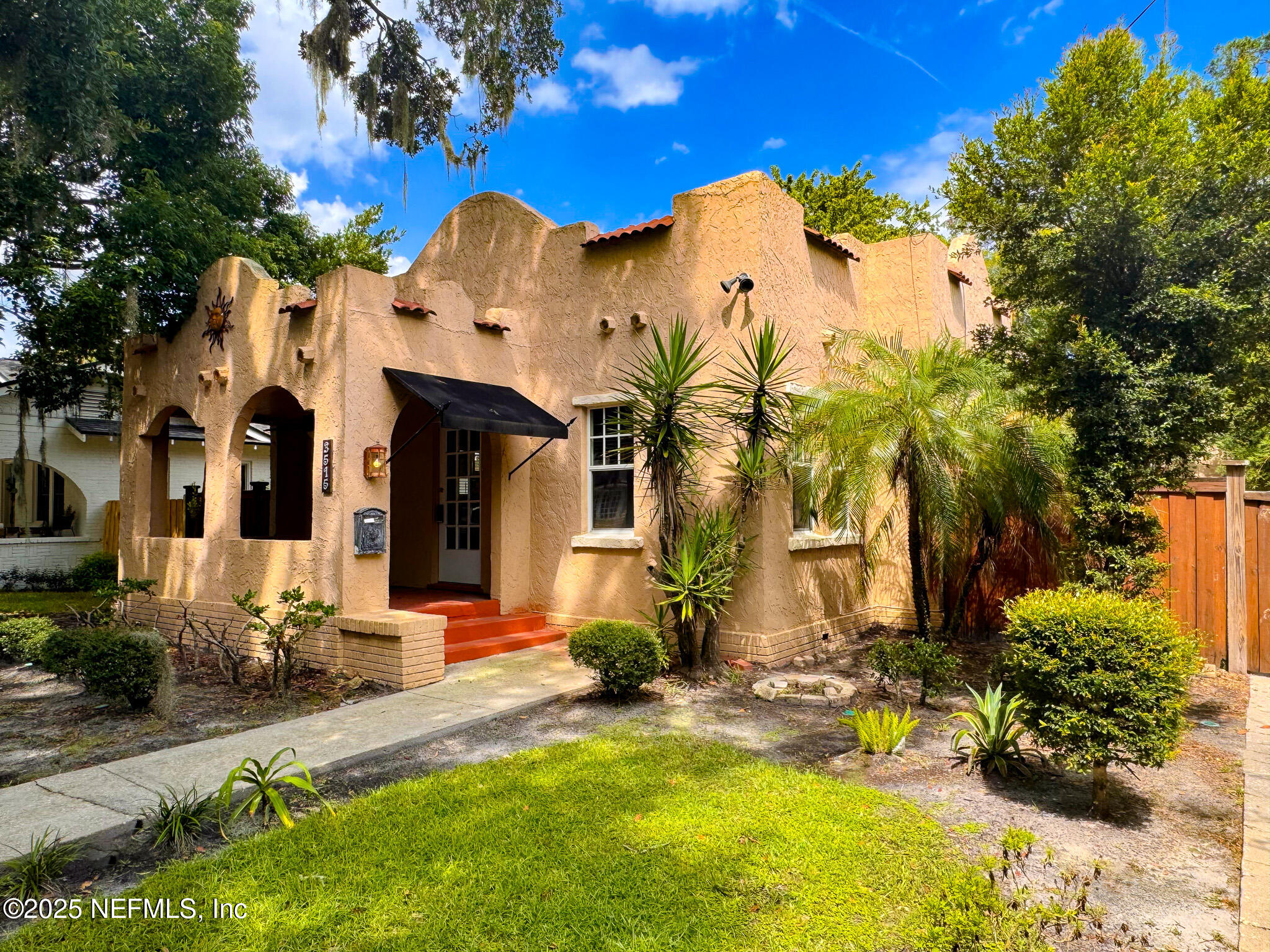 3515 Valencia Road Jacksonville, FL 32205 - Photo 24 of 24 a view of a house with a large tree and plants
