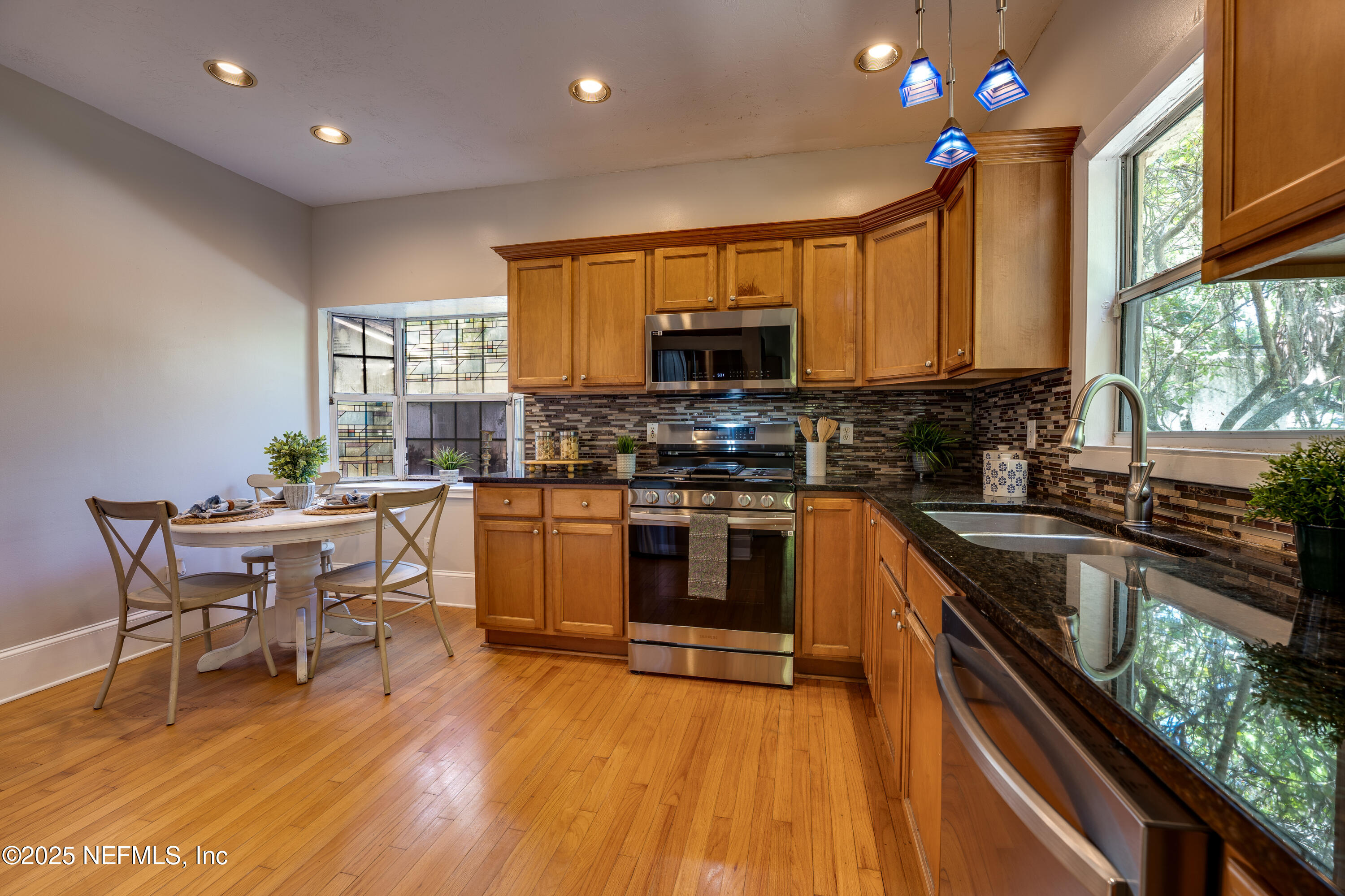 3515 Valencia Road Jacksonville, FL 32205 - Photo 6 of 24 a kitchen with a sink a counter top space stainless steel appliances and a large window