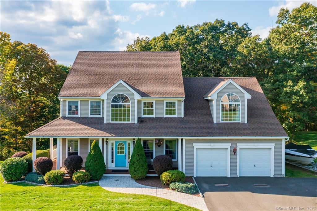 a aerial view of a house with yard and garage