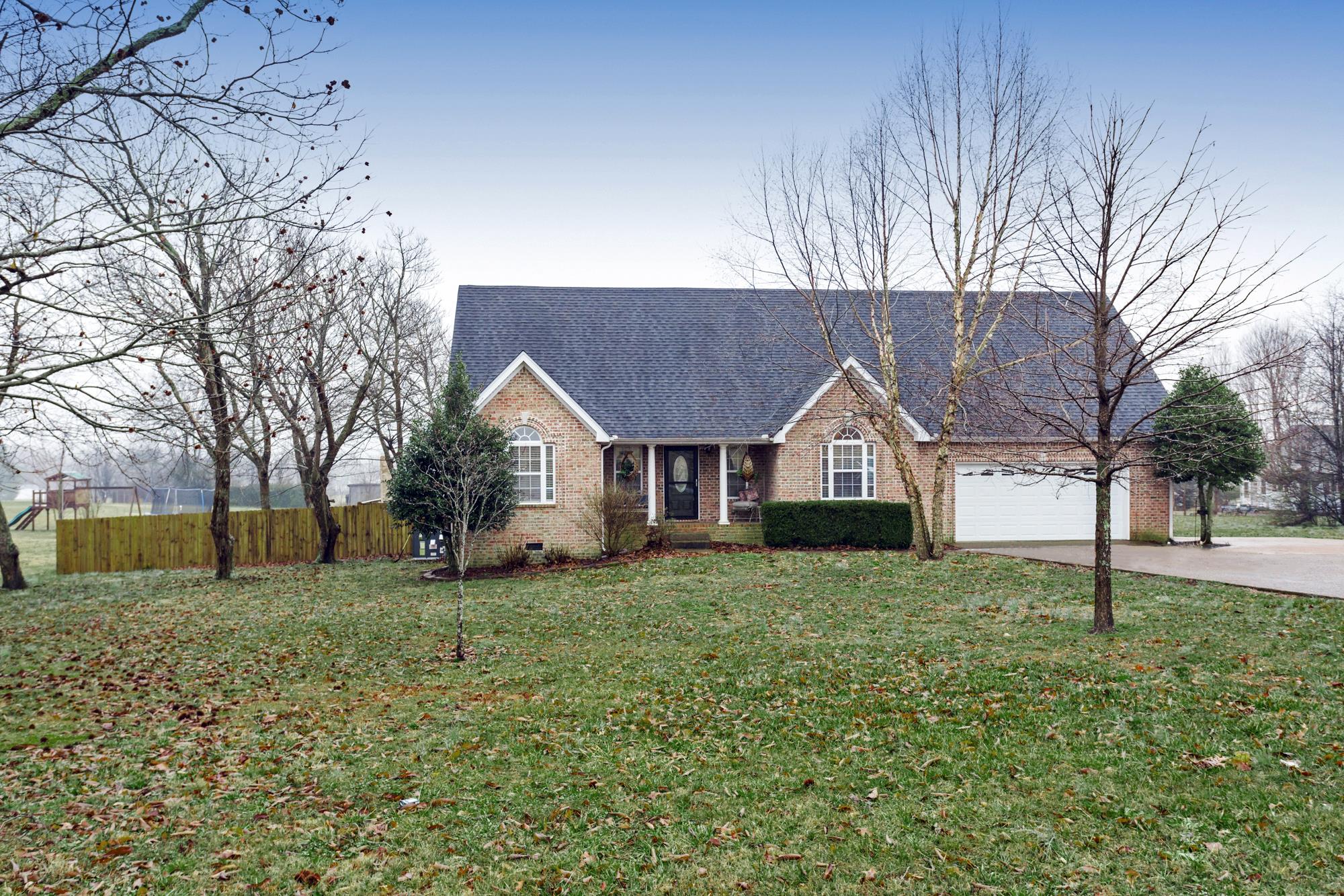 484 Fowler Ford Road Portland, TN 37148 - Photo 1 of 29 a house that is sitting in the grass with large trees