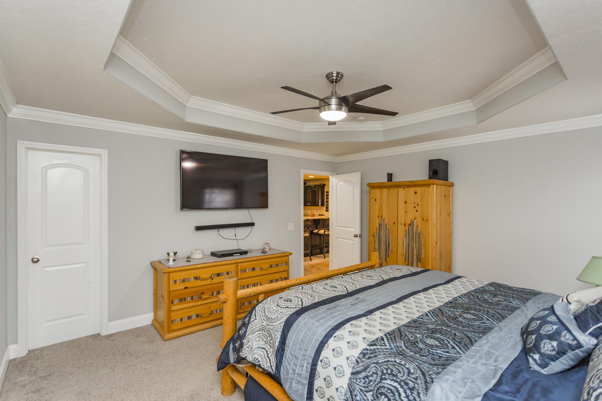 484 Fowler Ford Road Portland, TN 37148 - Photo 19 of 29 a bedroom with a bed and a flat screen tv