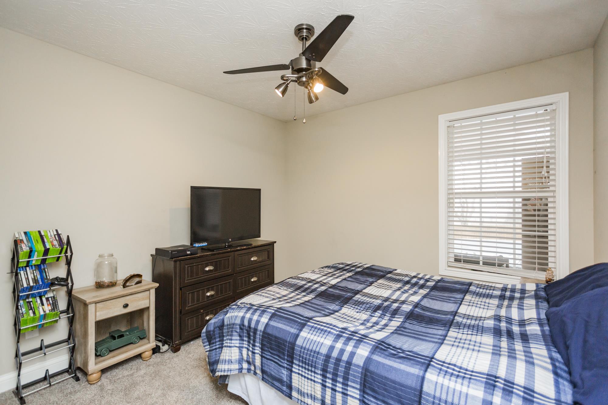 484 Fowler Ford Road Portland, TN 37148 - Photo 20 of 29 a bedroom with a bed and a tv