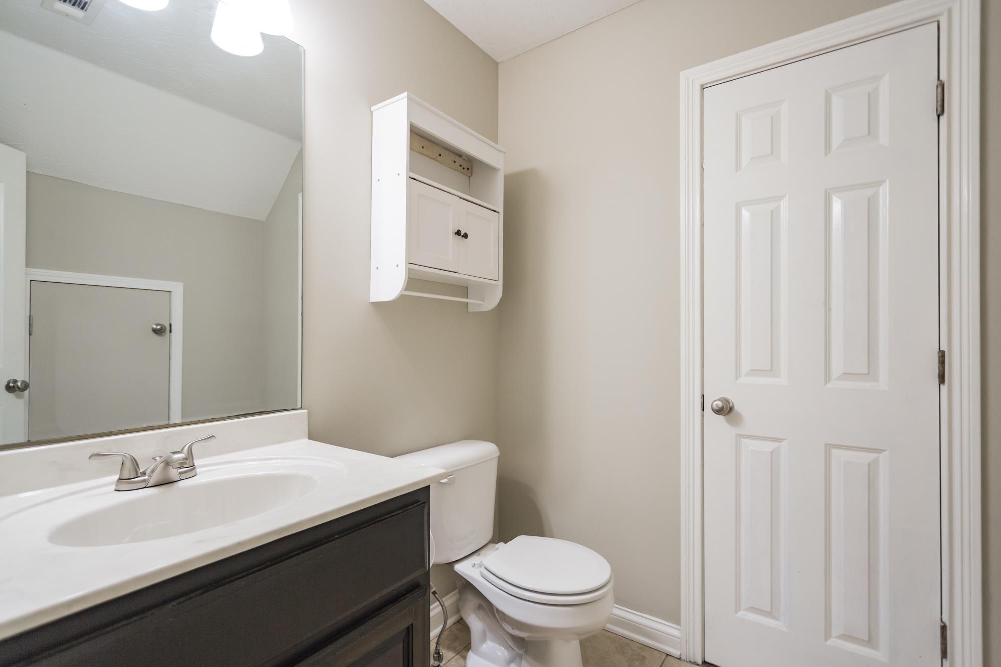 484 Fowler Ford Road Portland, TN 37148 - Photo 24 of 29 a bathroom with a sink a toilet and a mirror