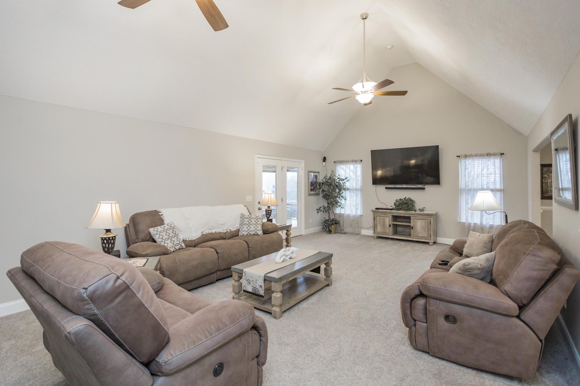 484 Fowler Ford Road Portland, TN 37148 - Photo 7 of 29 a living room with furniture a ceiling fan and a flat screen tv