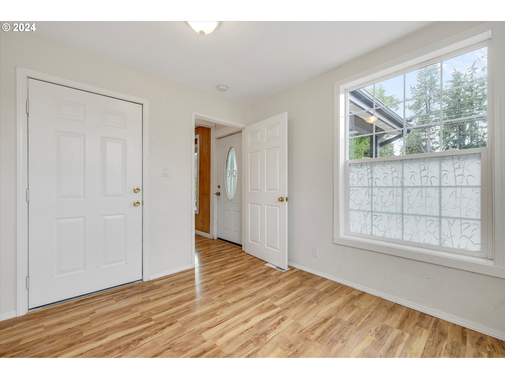 16265 Highway 224 Damascus, OR 97089 - Photo 10 of 40 a view of an empty room with wooden floor and a window