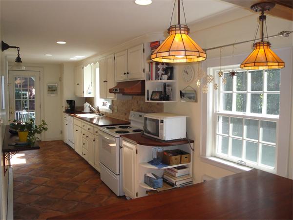 524 Concord Road Sudbury, MA 01776 - Photo 5 of 20 a kitchen with kitchen island granite countertop a stove a sink a refrigerator and a wooden floors