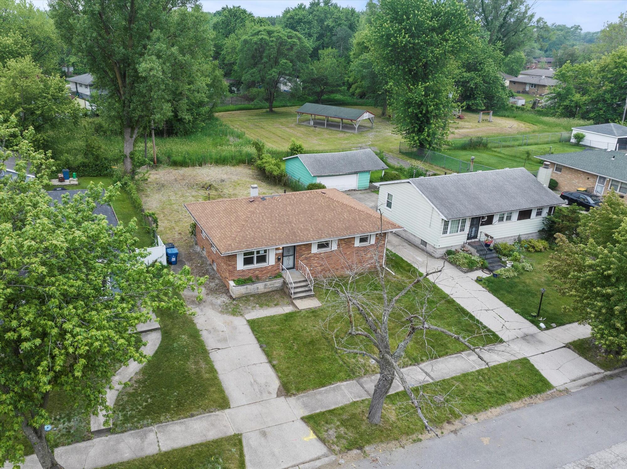 an aerial view of a house with garden space and street view