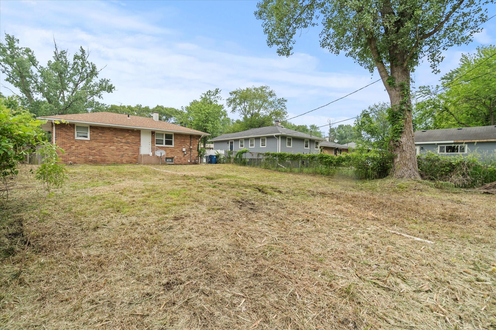 6715 East 3rd Avenue Gary, IN 46403 - Photo 11 of 25 a view of a house with a yard