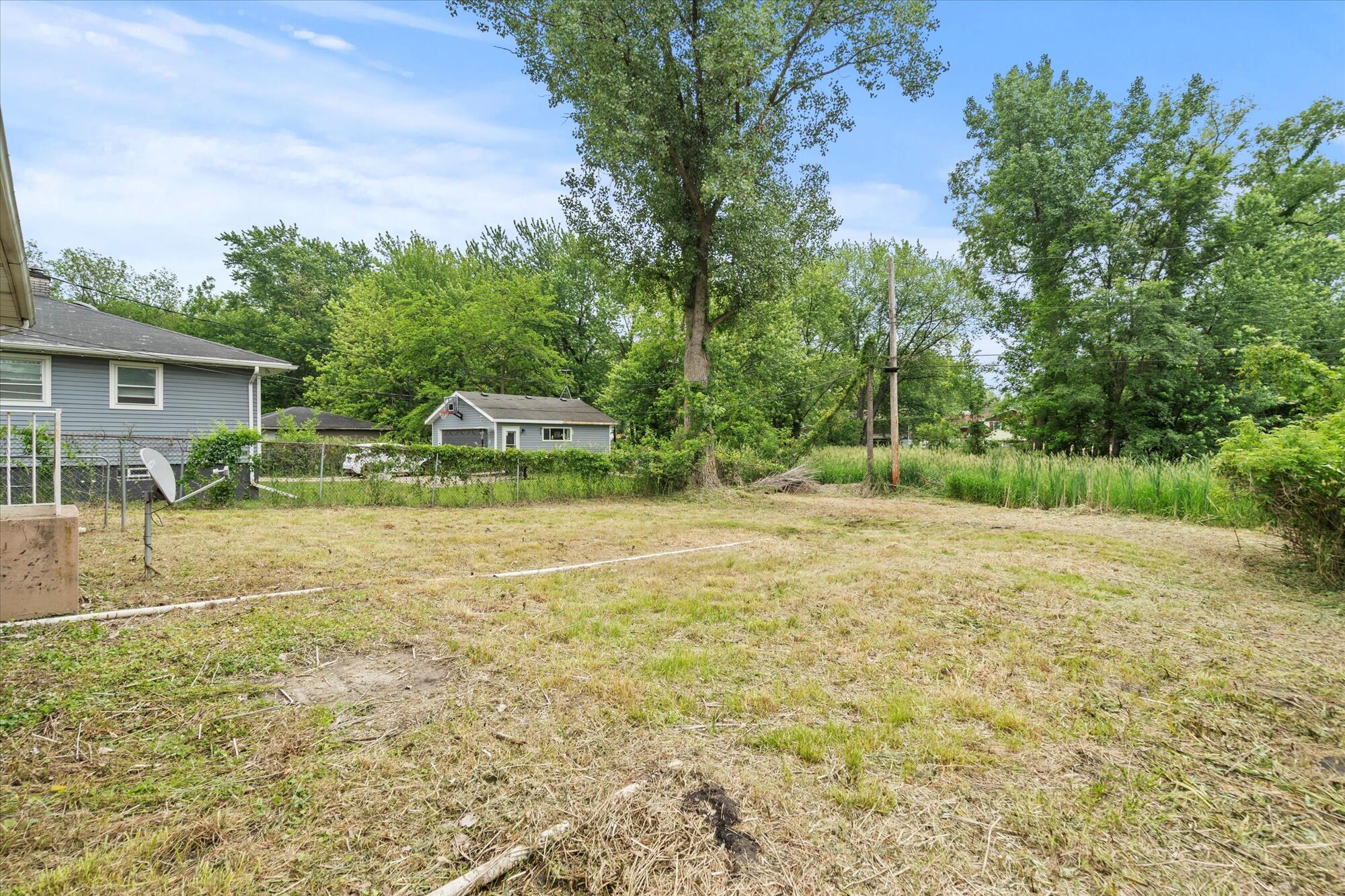 6715 East 3rd Avenue Gary, IN 46403 - Photo 12 of 25 a view of a backyard with a garden