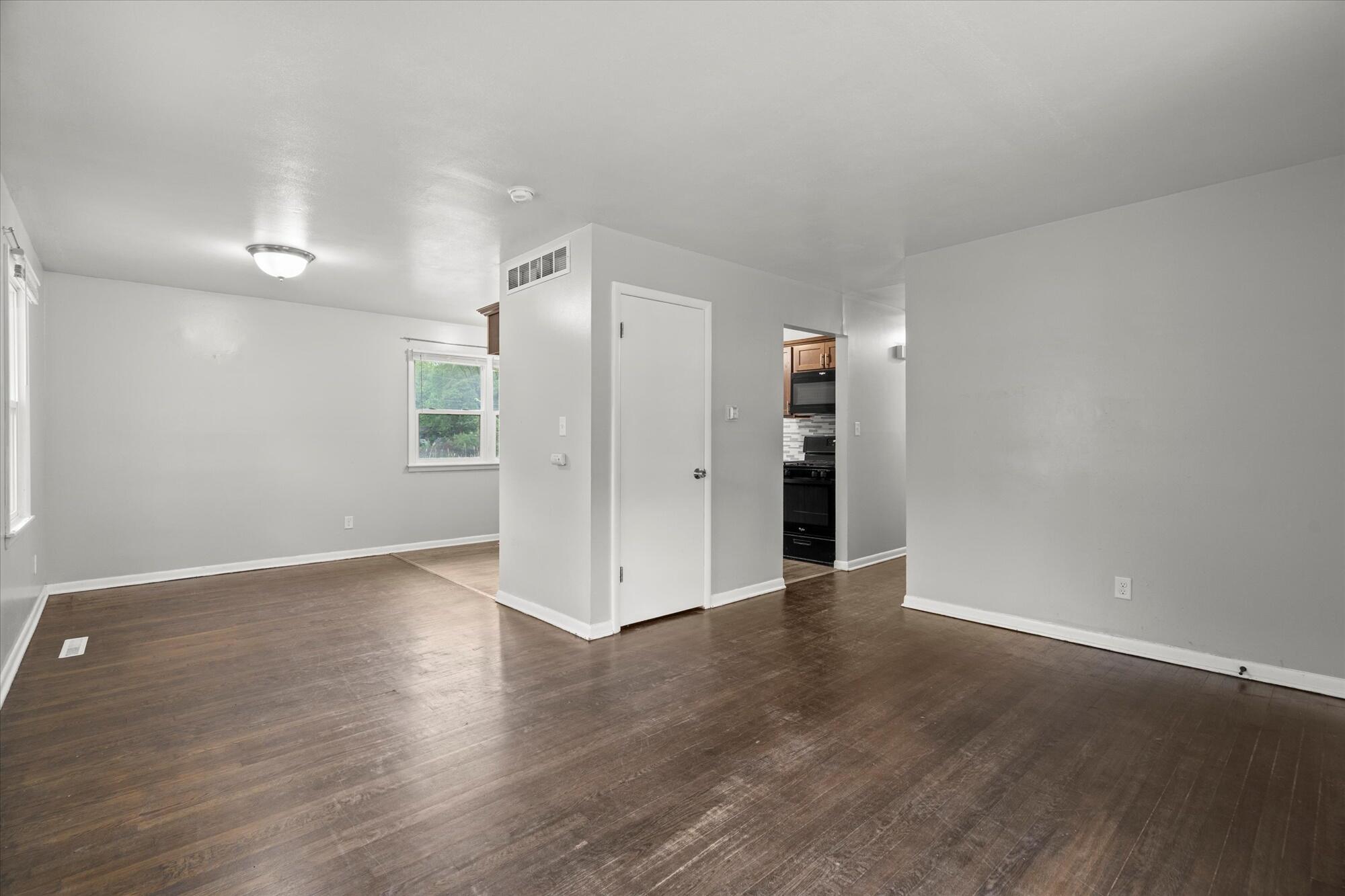 6715 East 3rd Avenue Gary, IN 46403 - Photo 16 of 25 an empty room with wooden floor and natural light