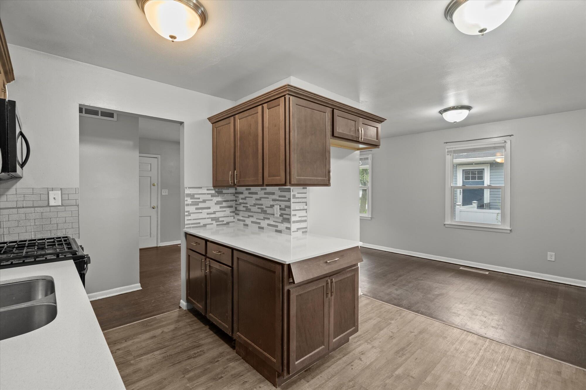 6715 East 3rd Avenue Gary, IN 46403 - Photo 19 of 25 a kitchen with a stove and a sink