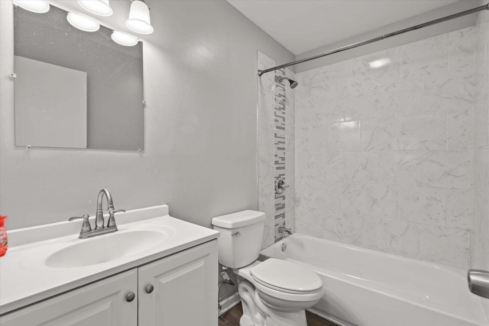 6715 East 3rd Avenue Gary, IN 46403 - Photo 22 of 25 a bathroom with a sink toilet vanity and shower