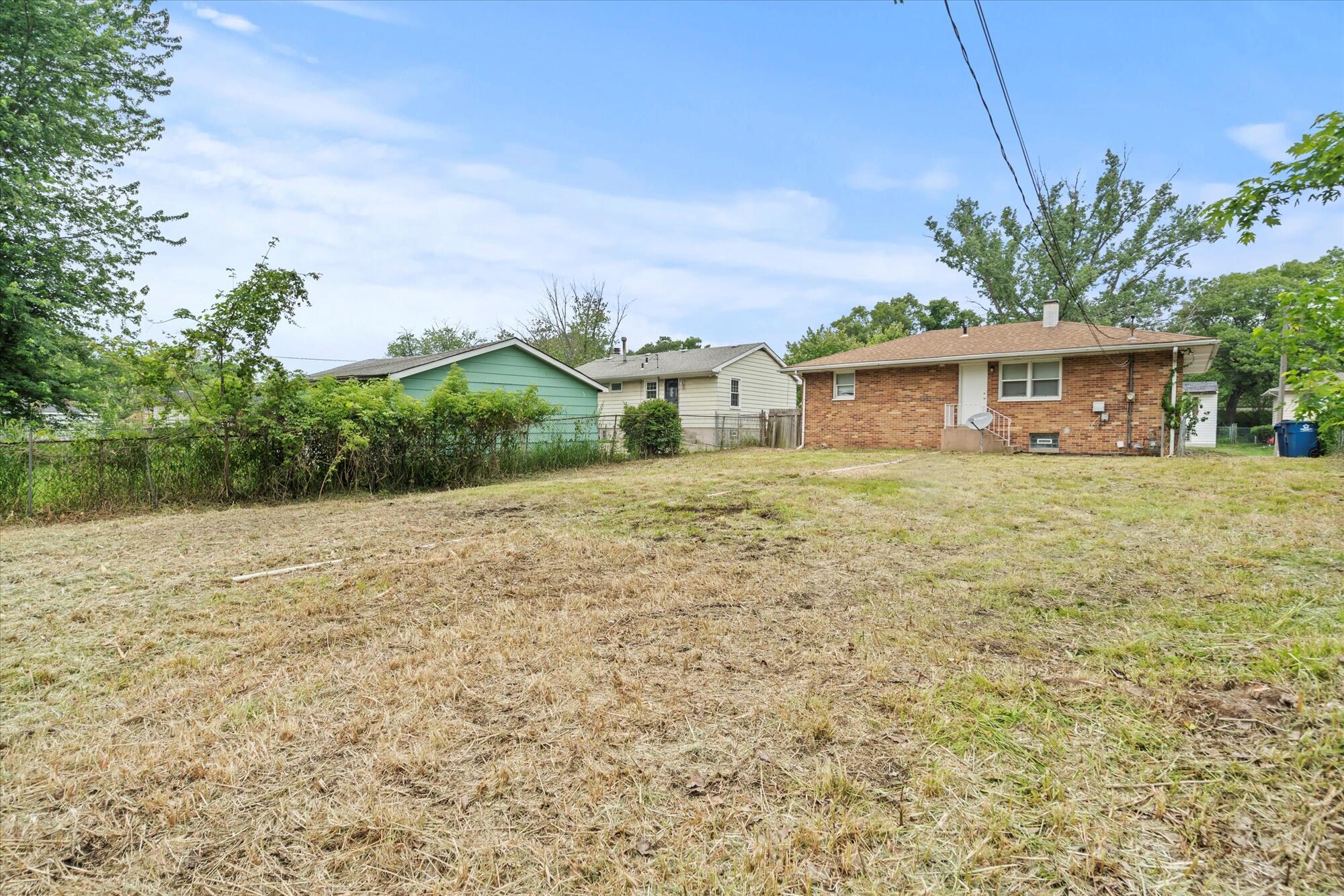 6715 East 3rd Avenue Gary, IN 46403 - Photo 9 of 25 a front view of a house with a yard and trees