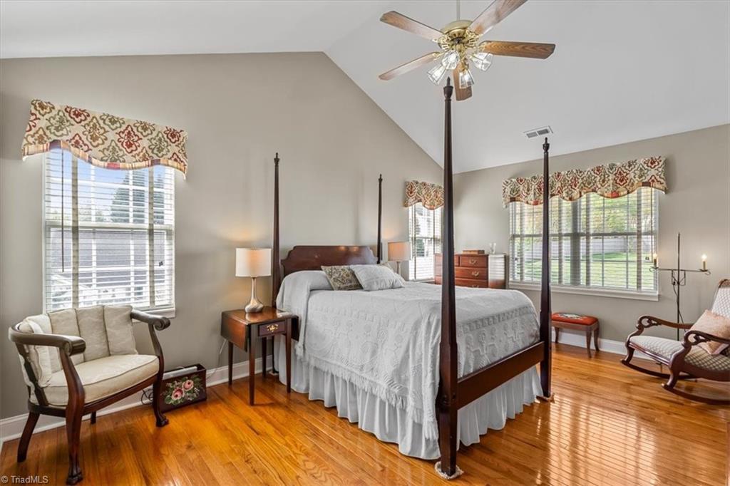 3303 Bardwell Road Greensboro, NC 27410 - Photo 26 of 50 Lovely primary bedroom features a vaulted ceiling and . . .