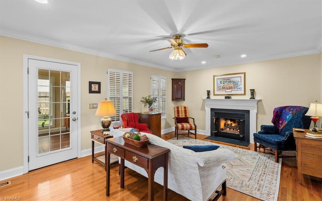 3303 Bardwell Road Greensboro, NC 27410 - Photo 8 of 50 Pass through to the cozy living room with a gas log fireplace perfect for those cold winter nights.