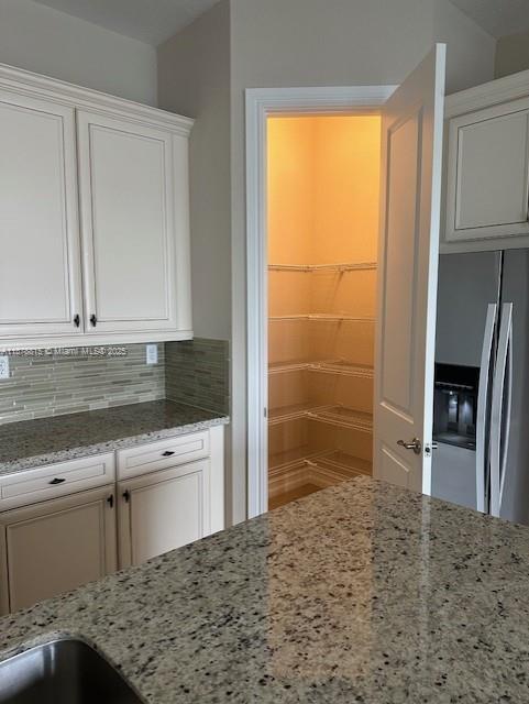 1415 Southwest 113th Avenue, Unit 1415 Pembroke Pines, FL 33025 - Photo 12 of 44 a kitchen with granite countertop a sink and a stove