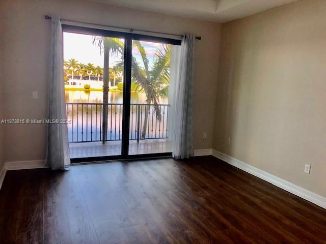 1415 Southwest 113th Avenue, Unit 1415 Pembroke Pines, FL 33025 - Photo 18 of 44 a view of an empty room with wooden floor and a window
