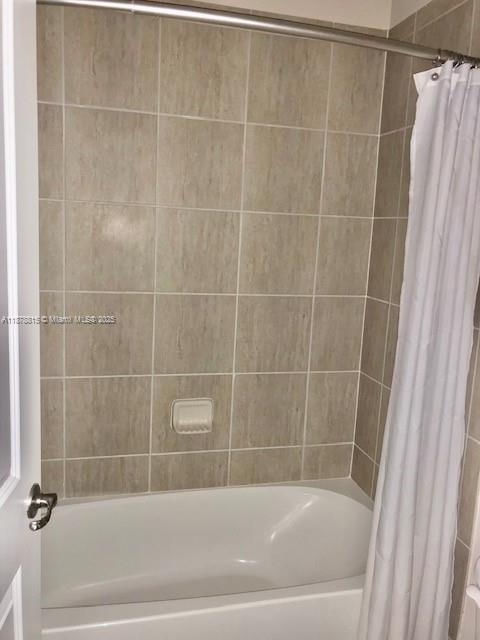 1415 Southwest 113th Avenue, Unit 1415 Pembroke Pines, FL 33025 - Photo 31 of 44 a white bath tub and a shower