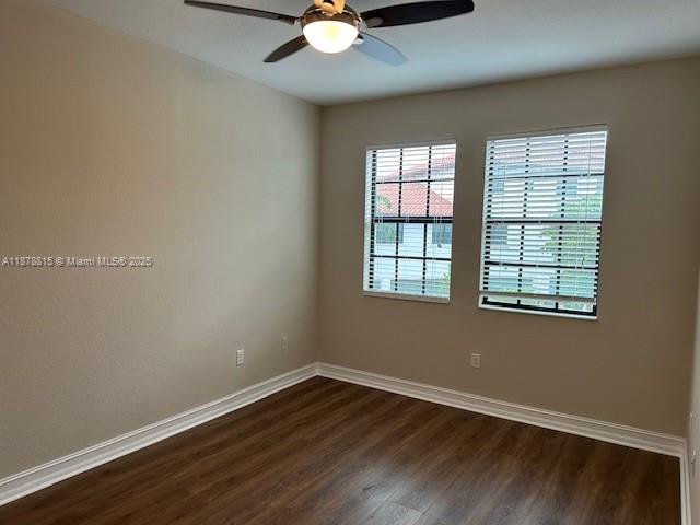 1415 Southwest 113th Avenue, Unit 1415 Pembroke Pines, FL 33025 - Photo 35 of 44 an empty room with wooden floor and windows