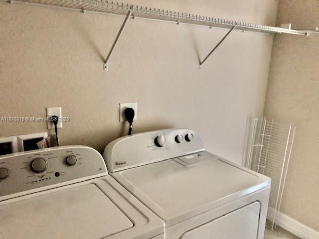 1415 Southwest 113th Avenue, Unit 1415 Pembroke Pines, FL 33025 - Photo 38 of 44 a utility room with dryer and washer