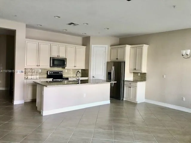 a kitchen with stainless steel appliances a refrigerator stove microwave and cabinets