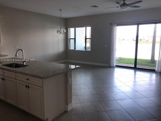 1415 Southwest 113th Avenue, Unit 1415 Pembroke Pines, FL 33025 - Photo 5 of 44 a kitchen with a sink a counter top and a window