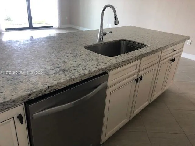 a close view of a sink a faucet and appliance in the kitchen