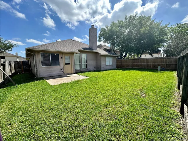 a front view of a house with yard and green space