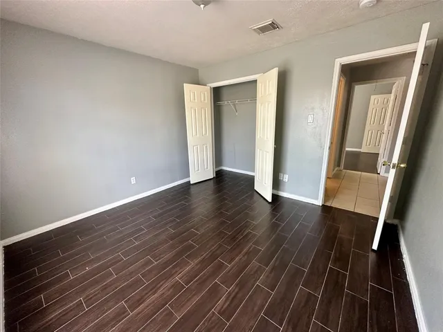 a view of a room with wooden floor and staircase