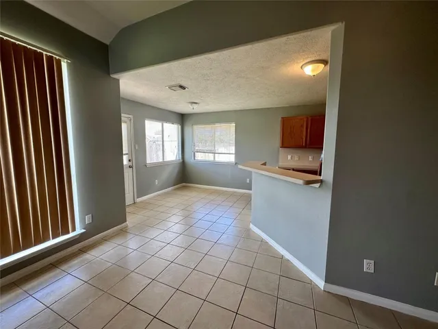 a view of a kitchen with kitchen island and natural light