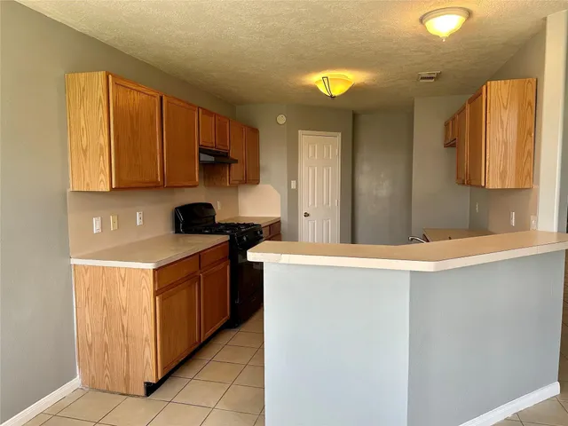a kitchen with stainless steel appliances granite countertop a sink and a stove