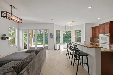a living room with furniture a flat screen tv and a large window