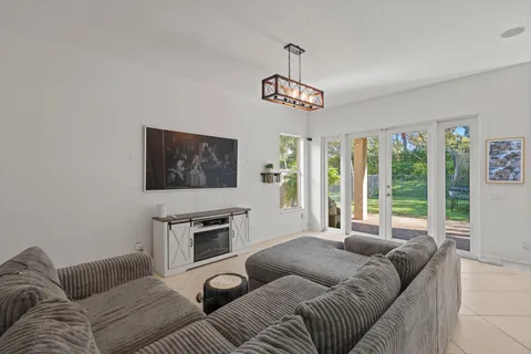 a living room with furniture a couch and a flat screen tv