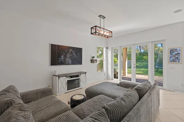 a living room with furniture a couch and a flat screen tv