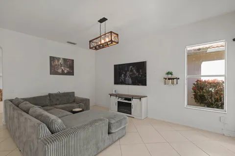 a living room with furniture and a kitchen view