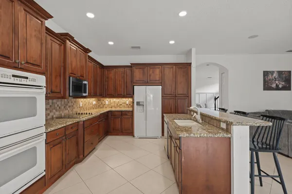 a kitchen with a stove a sink and a refrigerator