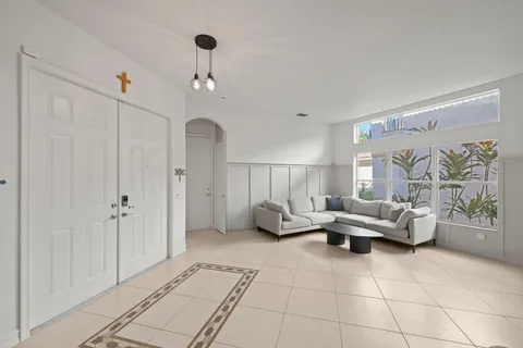 a living room with furniture and a chandelier