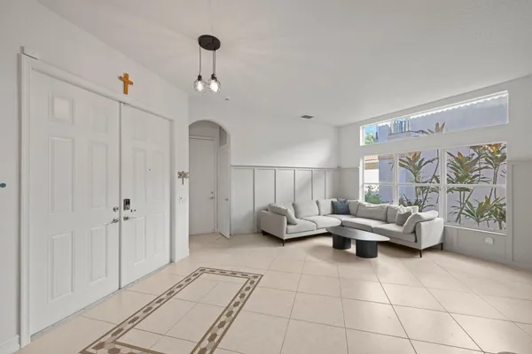 a living room with furniture and a chandelier