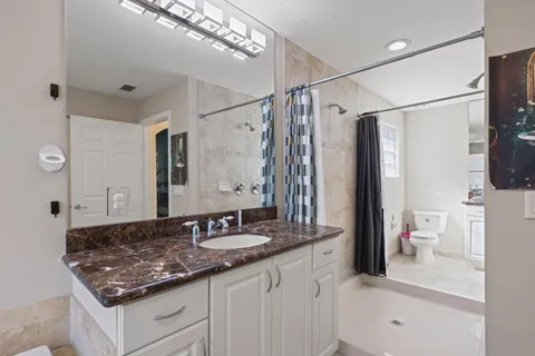 a spacious bathroom with a sink a bath tub and a shower