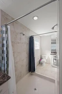 a bathroom with a double vanity sink mirror and shower