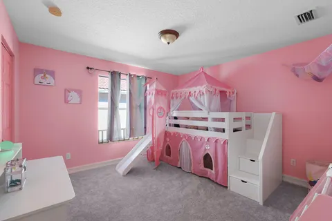 a bed room with a bed and a chair