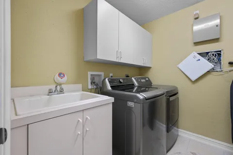 a aerial view of a house with a yard and potted plants